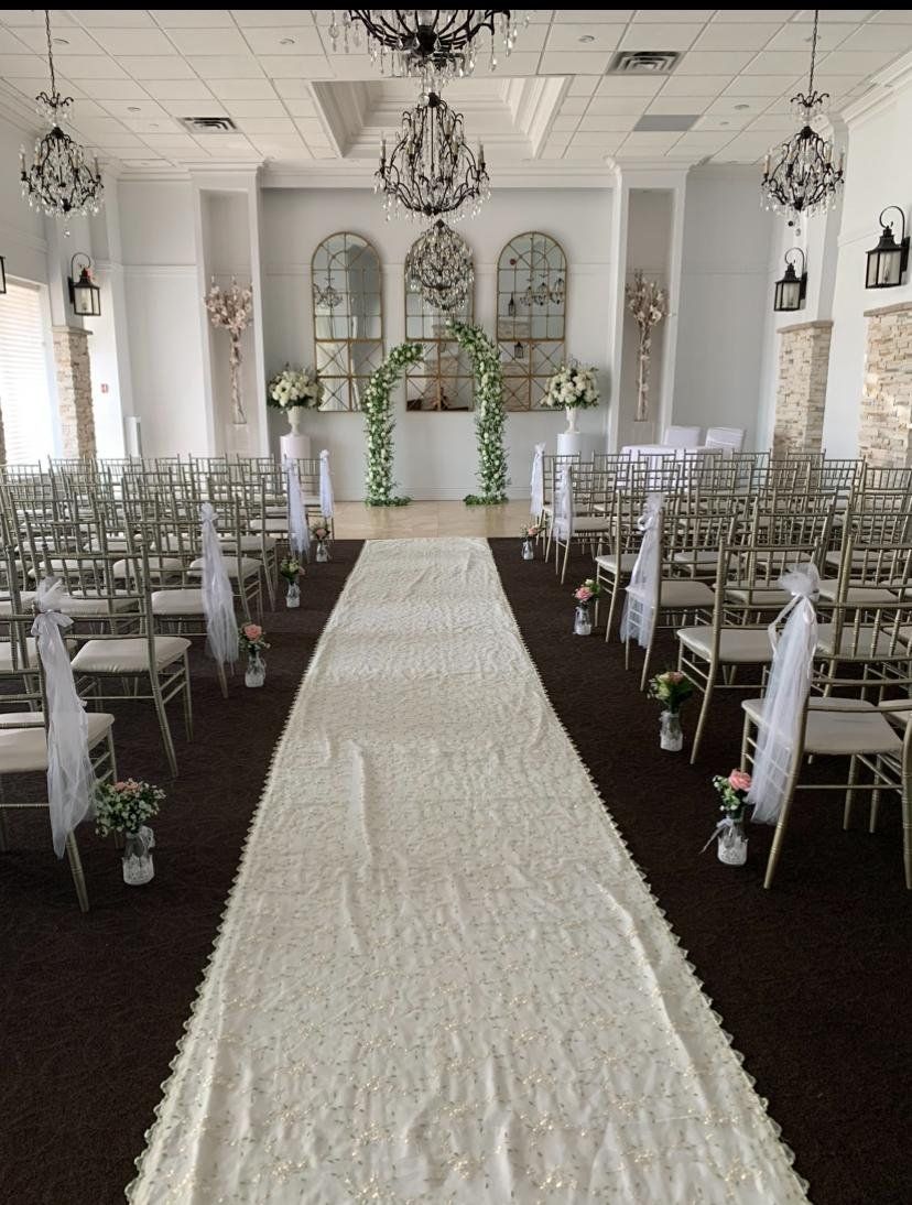 Ceremony room aisle runner, chair florals, arch