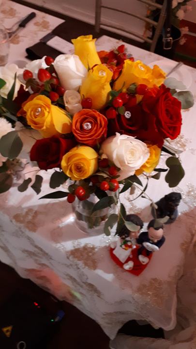 Red and yellow rose bouquet on table