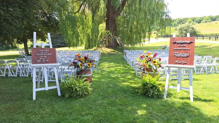 Outdoor ceremony, welcome signs on easels