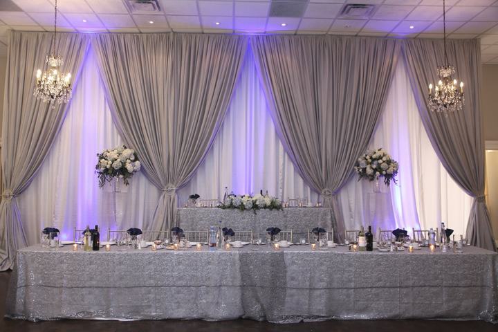 Grey drapery backdrop head table purple uplighting