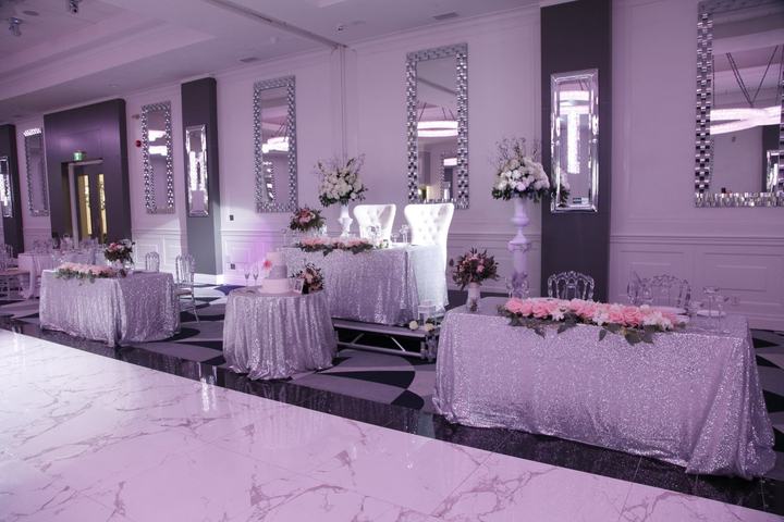 Room with sequin linens and purple uplighting