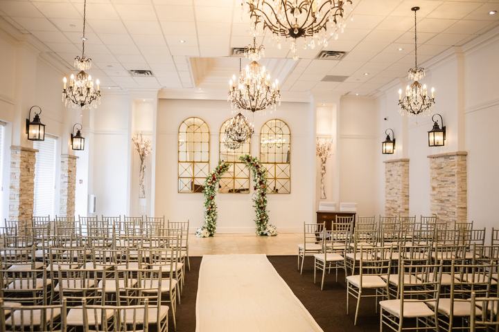 Ceremony room aisle floral arch chandeliers
