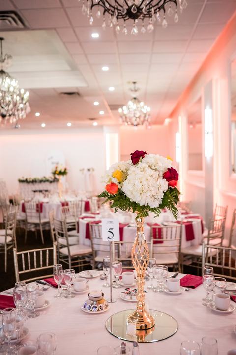 Gold centerpiece on table 5 under the chandeliers