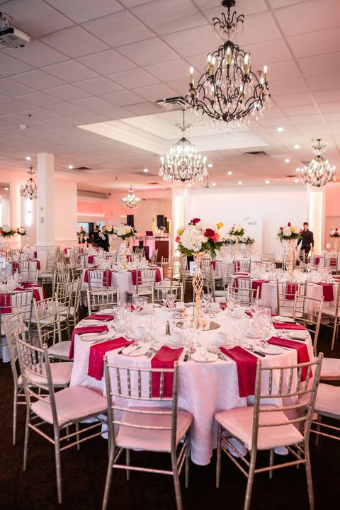 Ballroom wide, red and white tables, chandeliers