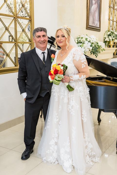 Couple by grand piano, mirrors
