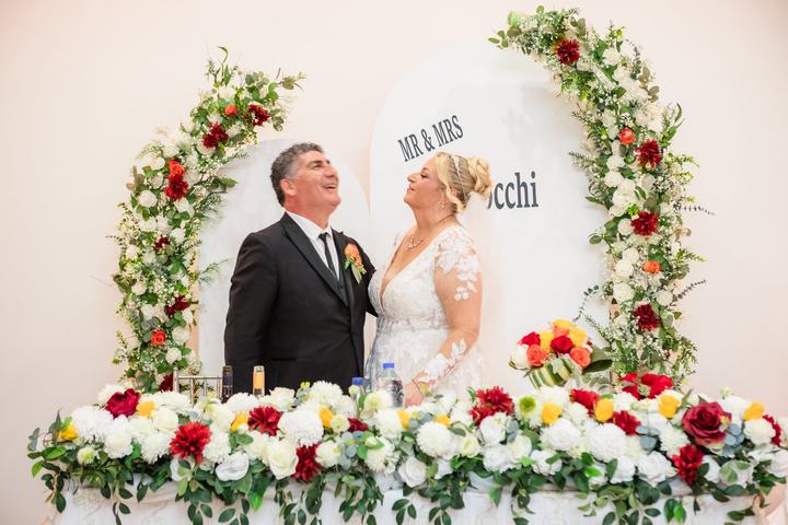 The couple at their floral head table