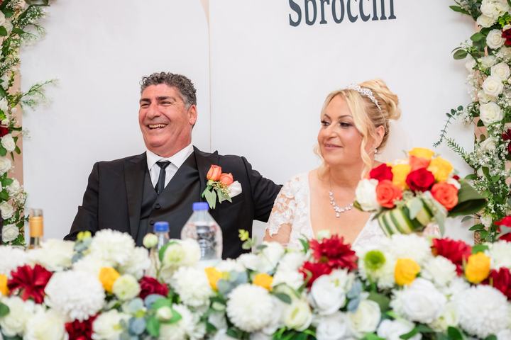 The couple seated behind the head table florals