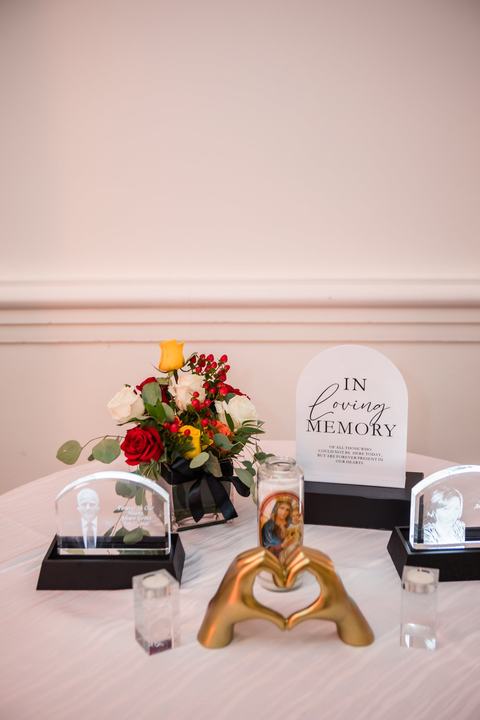 Memorial table with florals and gold heart hands