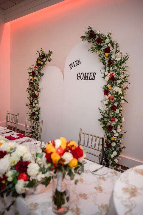 Head table arch for Mr & Mrs Gomes with florals