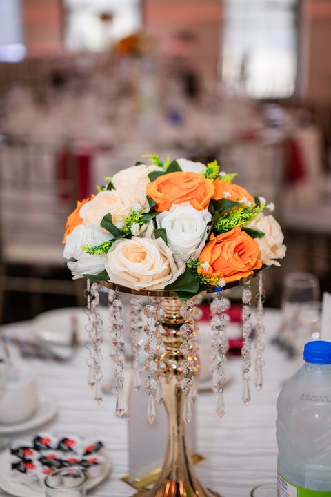 Orange and white centerpiece on a crystal stand