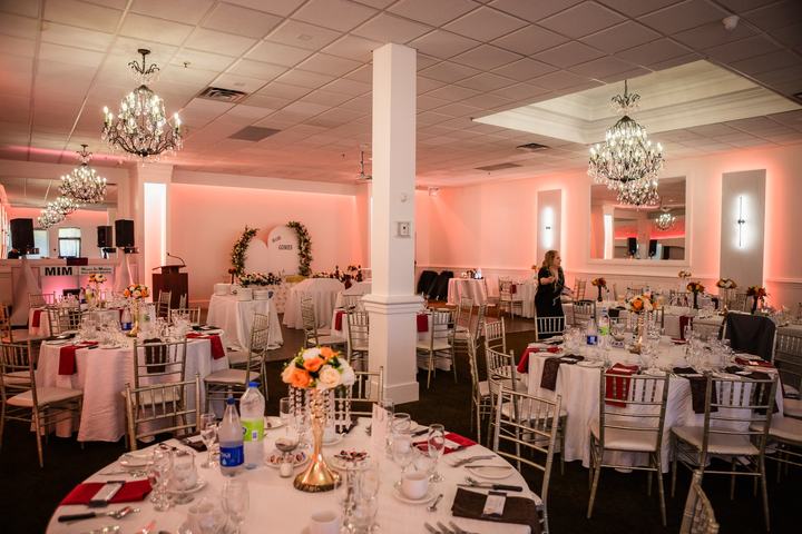 Ballroom wide pink uplighting, arch at back