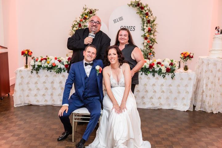 Newlyweds with the team at their head table