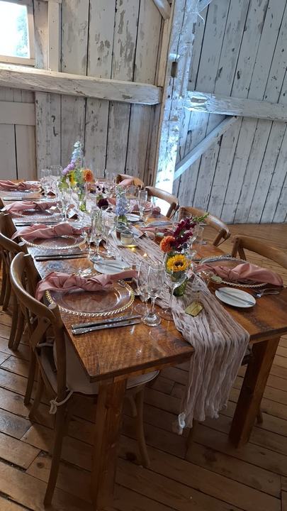 Rustic barn table pink napkins wildflowers
