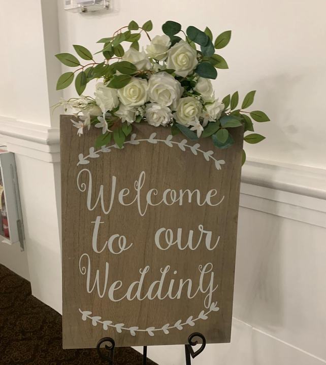 'Welcome to our Wedding' sign with florals