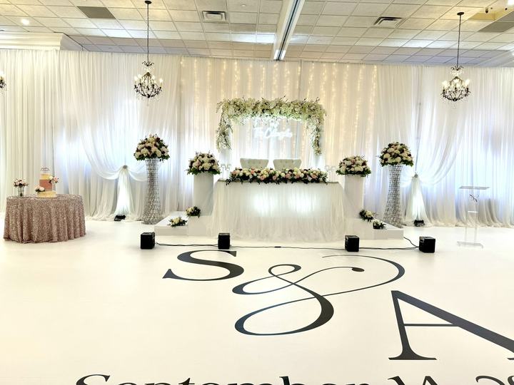 White floor wrap 'S & A September', head table with neon sign arch