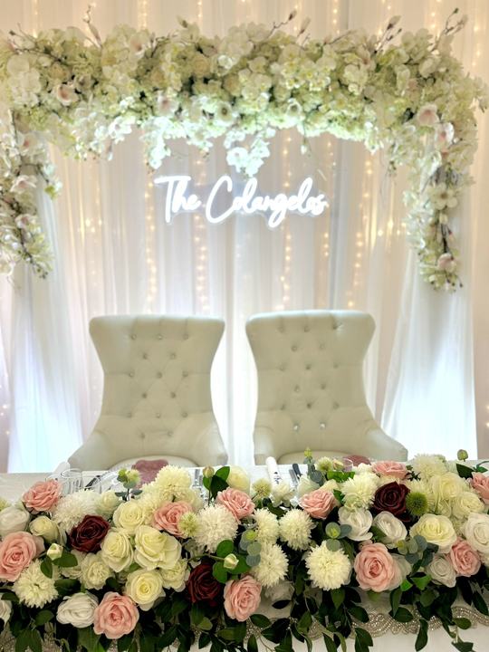 Neon 'The Colangelos' floral canopy, white thrones, florals