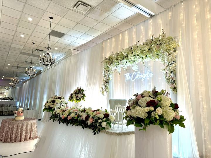 Head table floral canopy with a neon sign