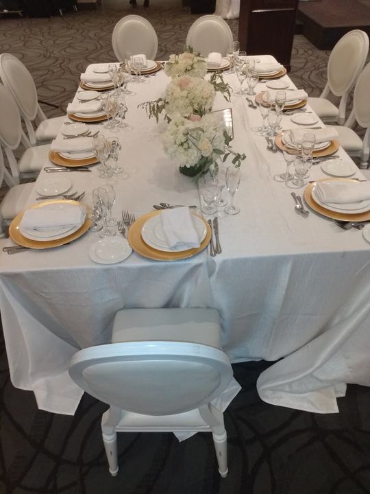 Long table gold chargers white florals