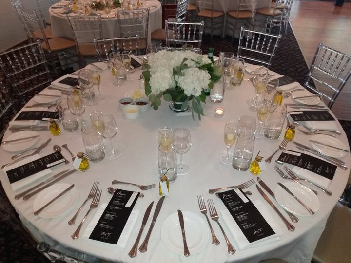 Overhead round table hydrangea centerpiece, black menus