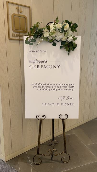 'unplugged ceremony' sign with florals