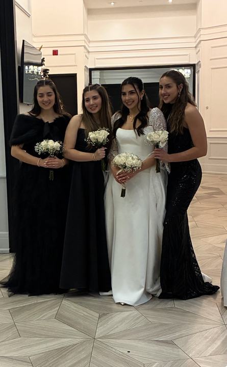 Bride and bridesmaids in black with white bouquets