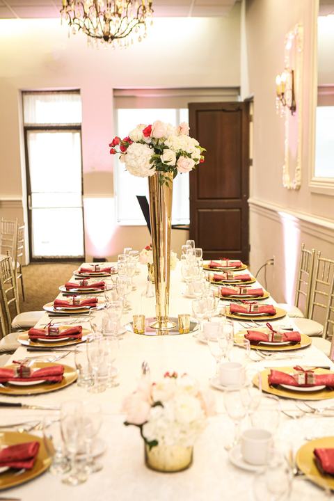 Long table gold trumpet centerpiece red napkins