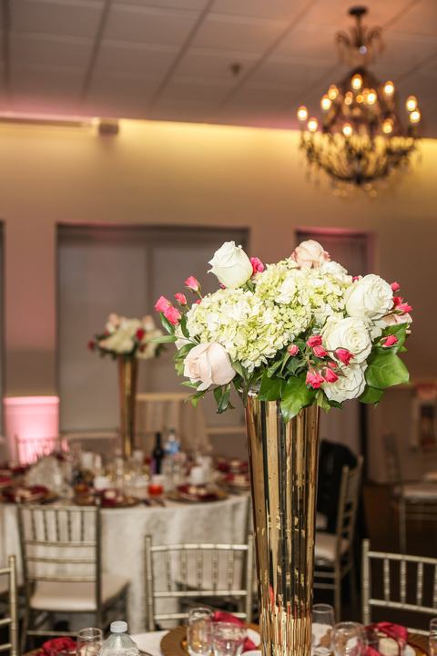 Tall gold vase centerpiece up close